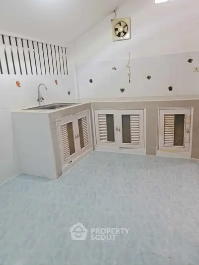 Charming kitchen with closed layout and ample cabinet space, perfect for culinary enthusiasts.