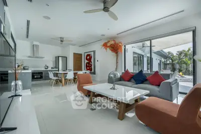 Modern open-plan living room with sleek kitchen and stylish decor