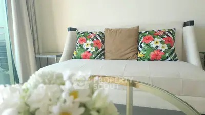 Chic living room with floral cushions and elegant glass coffee table