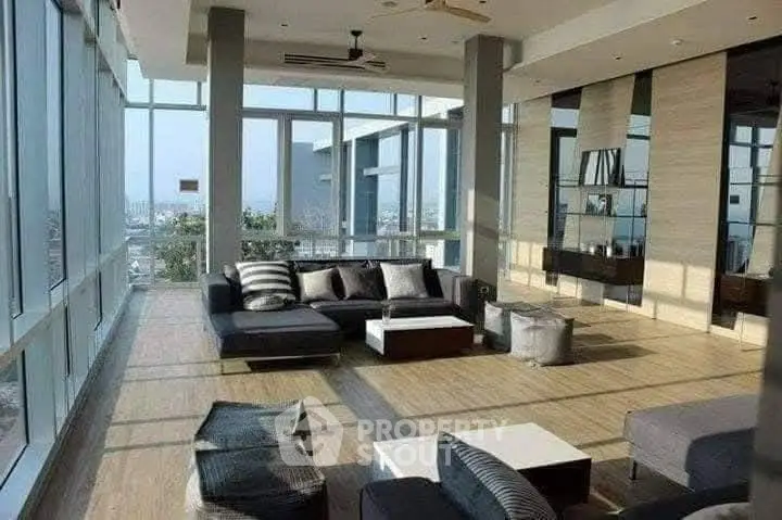 Luxurious modern living room with panoramic city views and stylish furniture.