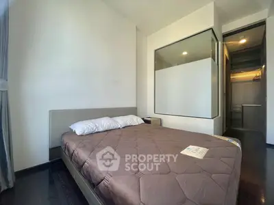 Modern bedroom with large window and walk-in closet in a stylish apartment