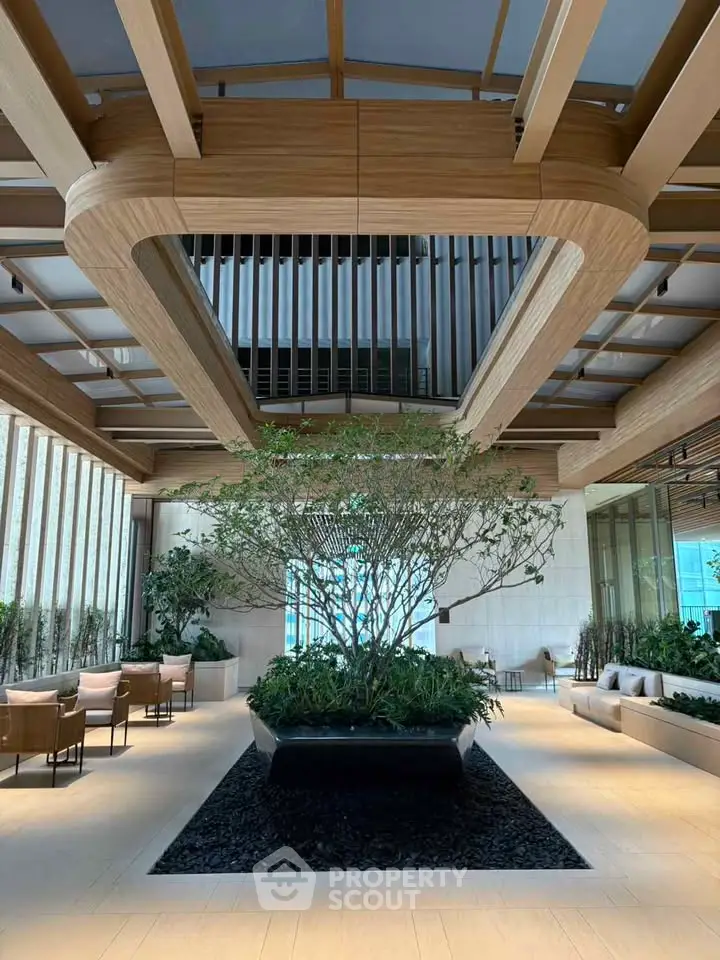 Luxurious modern lobby with elegant wooden ceiling and lush indoor garden centerpiece.