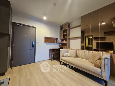 Modern living room with stylish sofa and wooden flooring in a contemporary apartment.