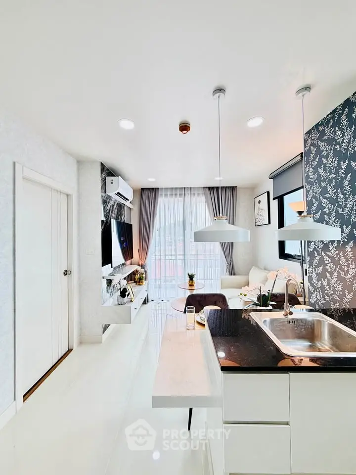 Modern open-layout living room with stylish kitchen island and elegant decor