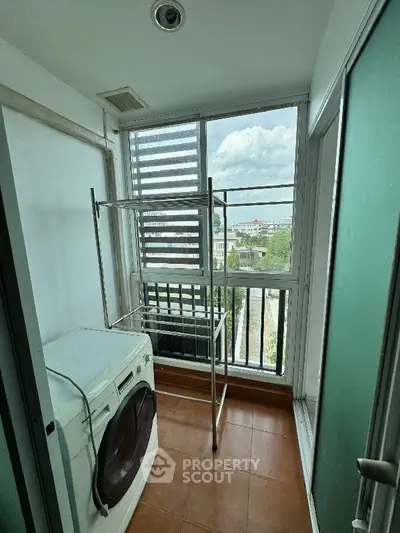 Cozy balcony with washing machine and scenic view, perfect for laundry and relaxation.
