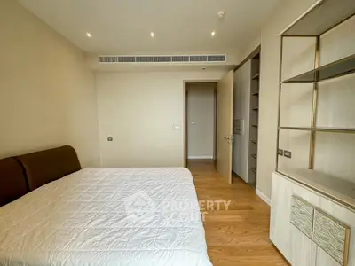 Spacious bedroom with modern design and wooden flooring