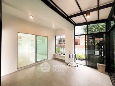 Spacious modern room with large windows and garden view