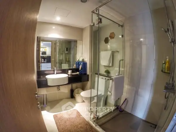 Modern bathroom with glass shower and sleek fixtures