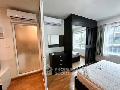 Modern bedroom with mirrored wardrobe and air conditioning in urban apartment