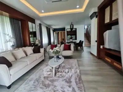Luxurious modern living room with elegant decor and open dining area, perfect for entertaining.