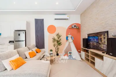 Stylish living room with modern decor, cozy seating, and entertainment setup.