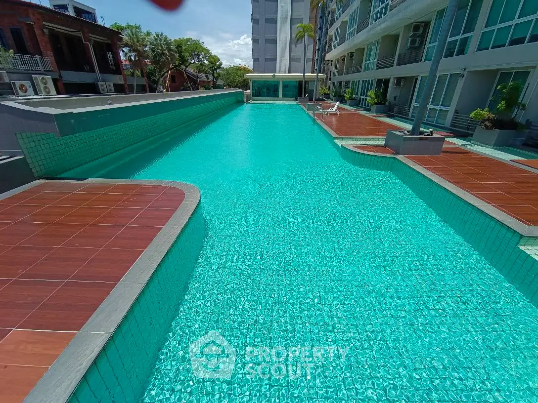 Luxurious apartment complex with stunning outdoor pool and modern design.