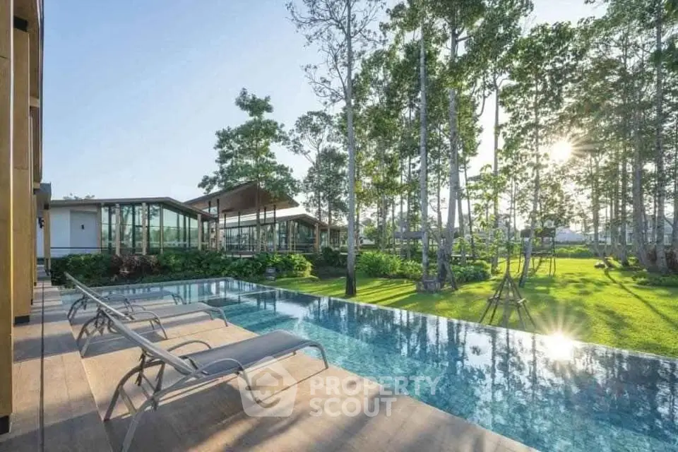 Luxurious modern home with stunning pool and lush garden view