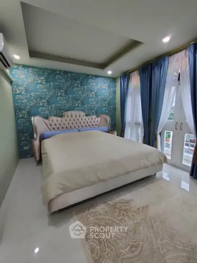 Luxurious bedroom with elegant decor and large windows for natural light.