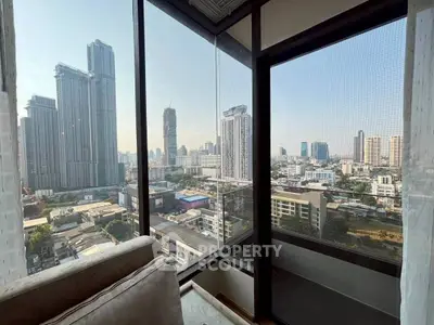Stunning cityscape view from high-rise apartment corner unit with floor-to-ceiling windows.