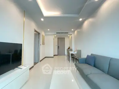 Spacious modern living room with sleek furniture and ambient lighting