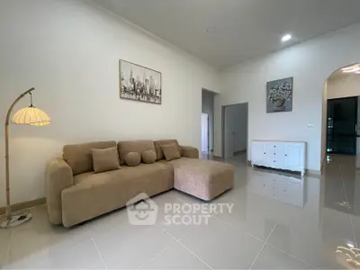 Spacious modern living room with elegant beige sofa and stylish decor