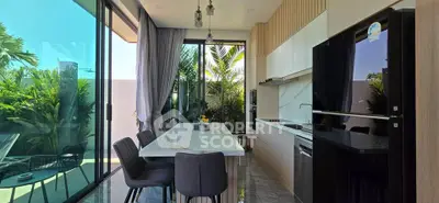 Modern kitchen with sleek design, large windows, and lush garden view, perfect for culinary enthusiasts.