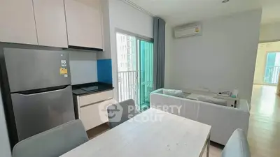Modern apartment interior with dining area and balcony view