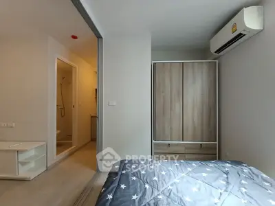 Modern bedroom with ensuite bathroom and air conditioning in a stylish apartment.