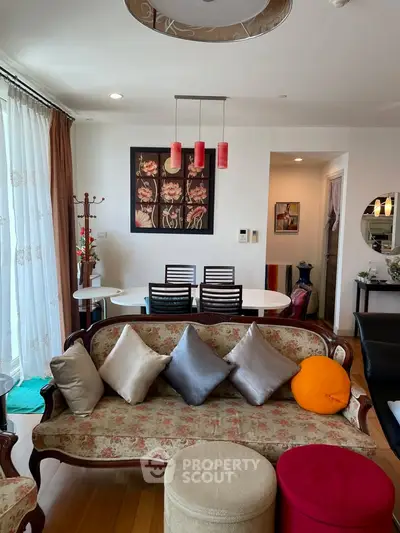 Charming living room with elegant decor and cozy seating in a modern apartment.