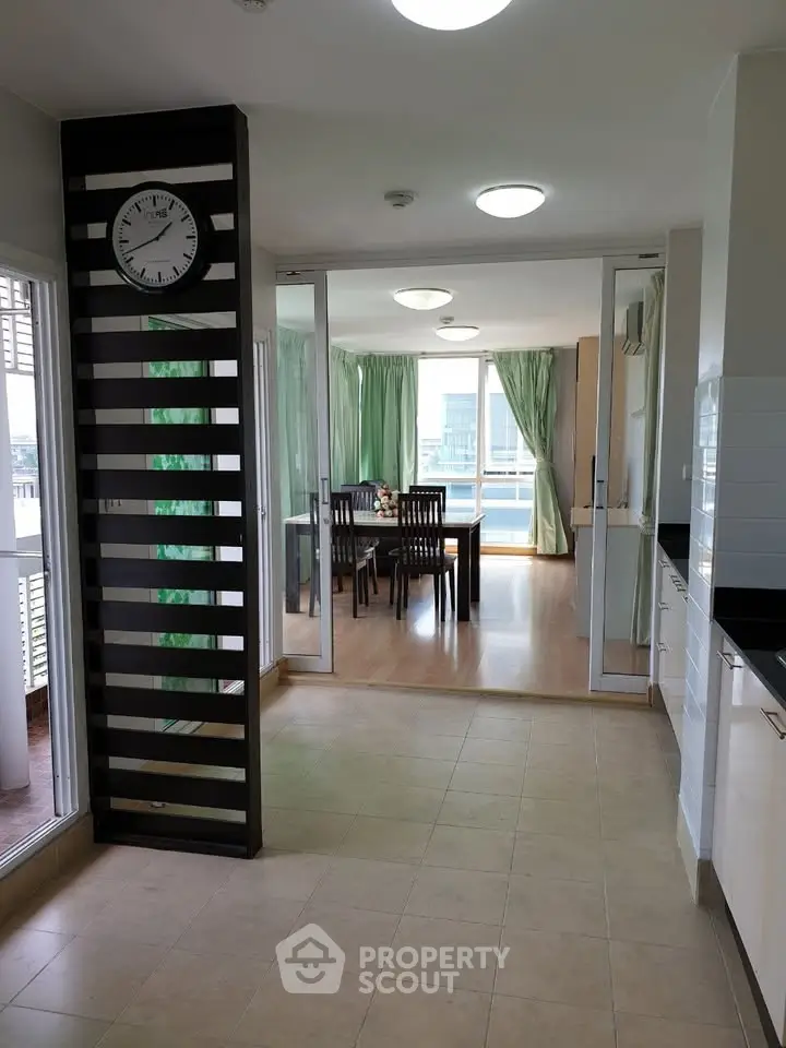 Spacious open-plan kitchen and dining area with modern decor and large windows.