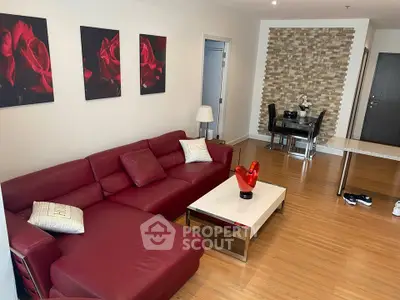 Stylish living room with red leather sofa and modern decor in a contemporary apartment.