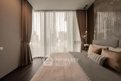 Luxurious bedroom with floor-to-ceiling windows and elegant decor in a modern apartment.