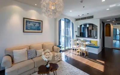 Stylish living room with modern decor and open kitchen layout in a luxurious apartment.