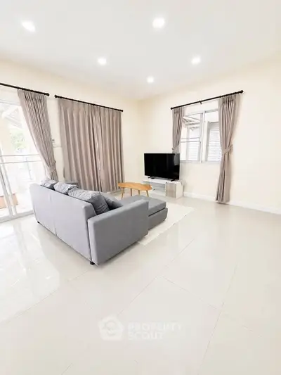 Spacious living room with modern decor and large windows for natural light.