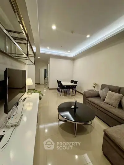 Spacious modern living room with sleek furniture and elegant lighting, perfect for relaxation and entertainment.