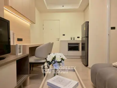 Modern living room with sleek kitchen, cozy seating, and elegant decor in a stylish apartment.