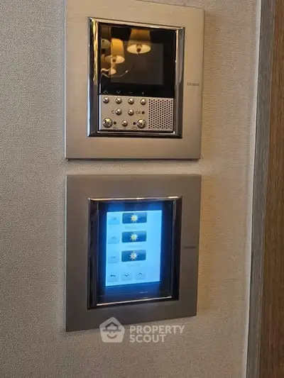 Modern home automation control panels on a wall, showcasing smart home technology.