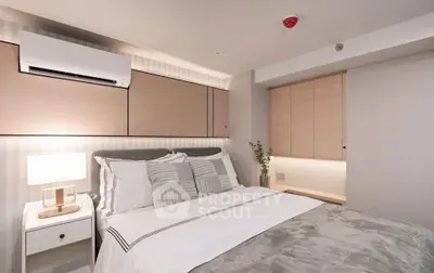 Modern bedroom with stylish decor and built-in storage in a cozy apartment.
