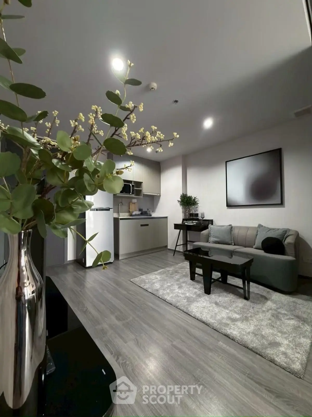 Modern living room with sleek kitchen and stylish decor