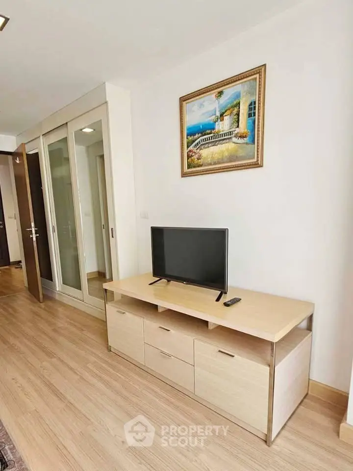 Modern living room with sleek TV stand and elegant decor in a stylish apartment.
