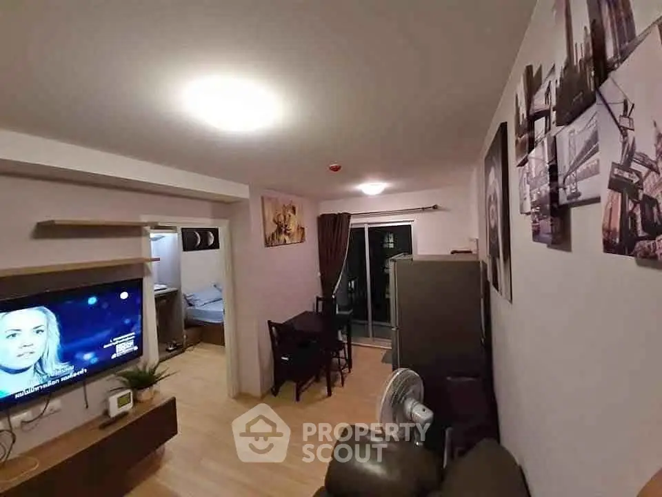Cozy living room with modern decor and balcony access in a stylish apartment.