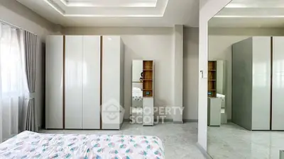 Modern bedroom with sleek wardrobe and stylish decor