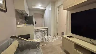 Modern compact living room with sleek kitchen and stylish furniture in urban apartment