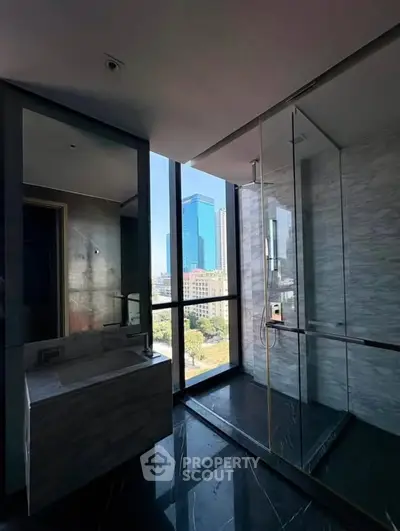Luxurious bathroom with city view and modern glass shower enclosure
