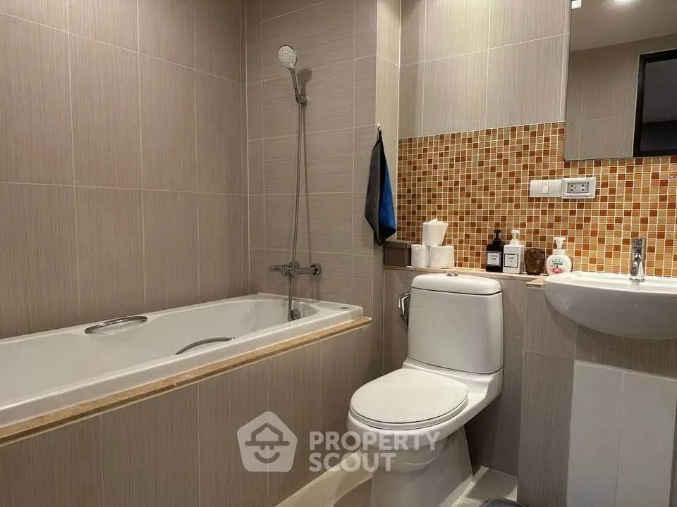 Modern bathroom with bathtub and stylish tile accents in a contemporary apartment.