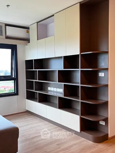 Modern living room with custom built-in shelving and large window view