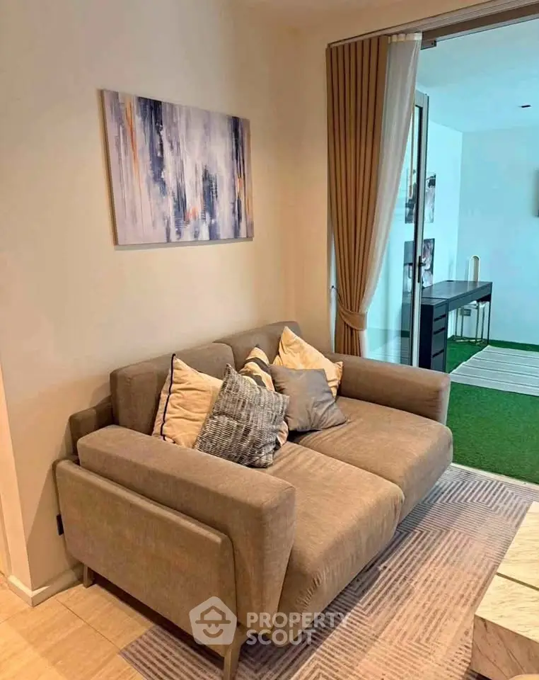 Cozy living room with modern sofa and abstract art, perfect for relaxation.