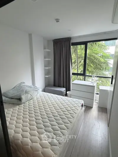 Modern bedroom with large windows and stylish decor