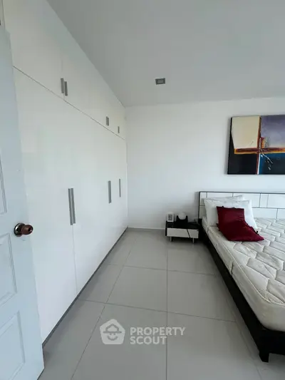 Modern bedroom with sleek white wardrobe and stylish decor