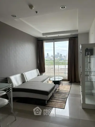 Modern living room with city view, featuring sleek furniture and large windows for natural light.
