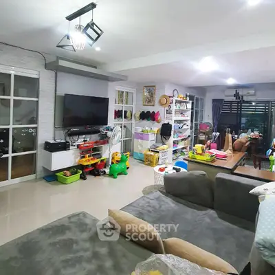 Spacious living room with modern decor and ample natural light, perfect for family gatherings.
