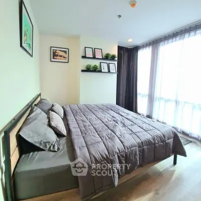 Modern bedroom with large window and stylish decor