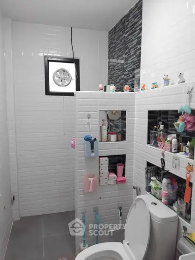 Modern bathroom with white subway tiles and organized shelves
