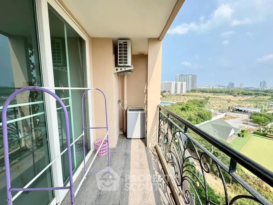 Spacious balcony with city view, perfect for relaxation and enjoying the outdoors.